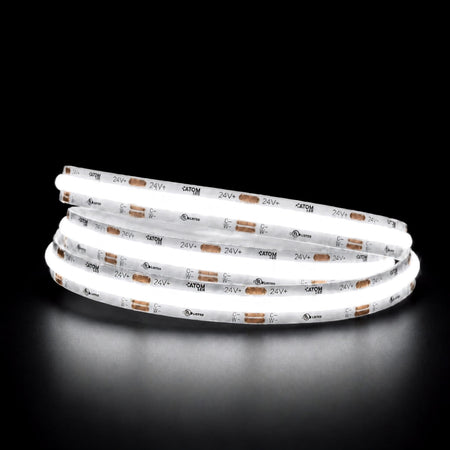 Daylight 5000K COB LED strip illuminated in a coil against a black background