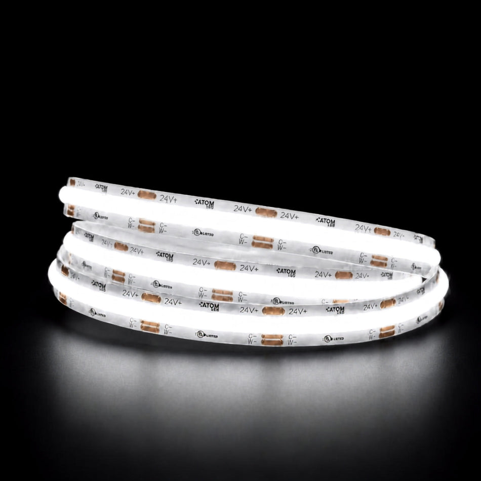 Daylight 5000K COB LED strip illuminated in a coil against a black background