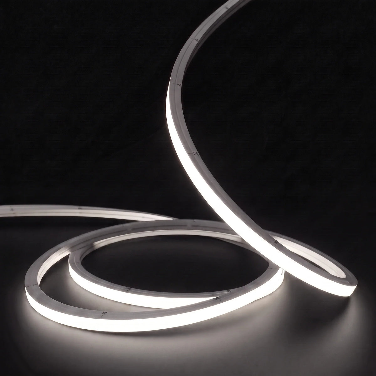 Neutral White 4000K LED Neon Flex 15x15mm Top Bend, low concentric coils with raised arc and colour glow on a black surface