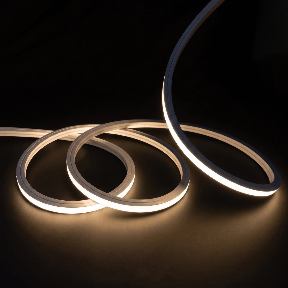 Warm White 3000K LED Neon Flex 15x15mm Top Bend, overlapping offset coils with raised arc and colour glow on a black surface