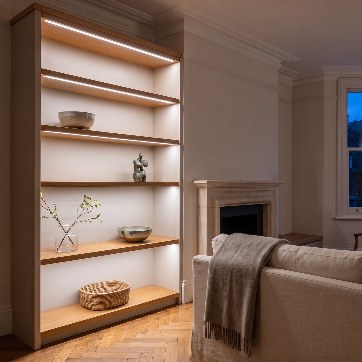 5000K white COB LED strip lighting beneath bespoke shelves in an elegant British home's sitting room