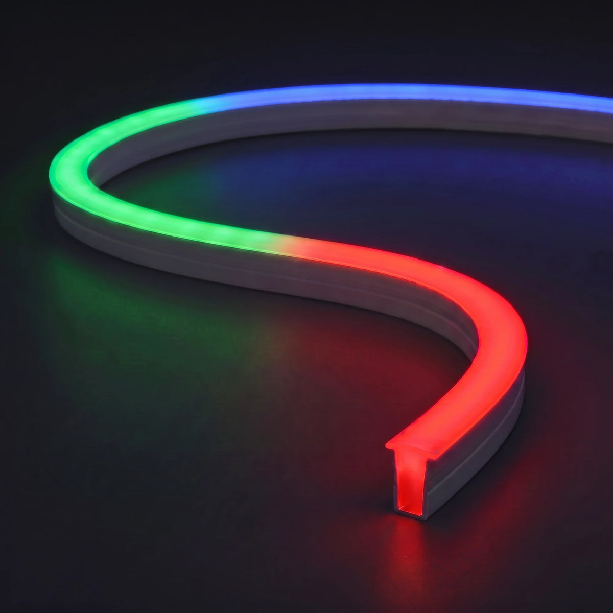 RGB silicone neon flex with a T-shaped diffuser and red, green and blue light on a dark charcoal surface