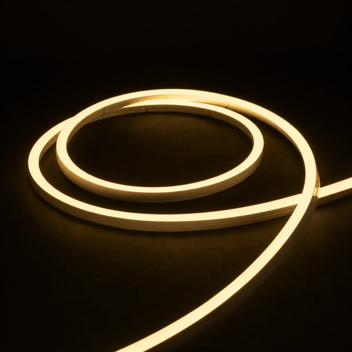 2700K side-bend Neon Flex coiled on a dark surface, colour-adjusted product photograph