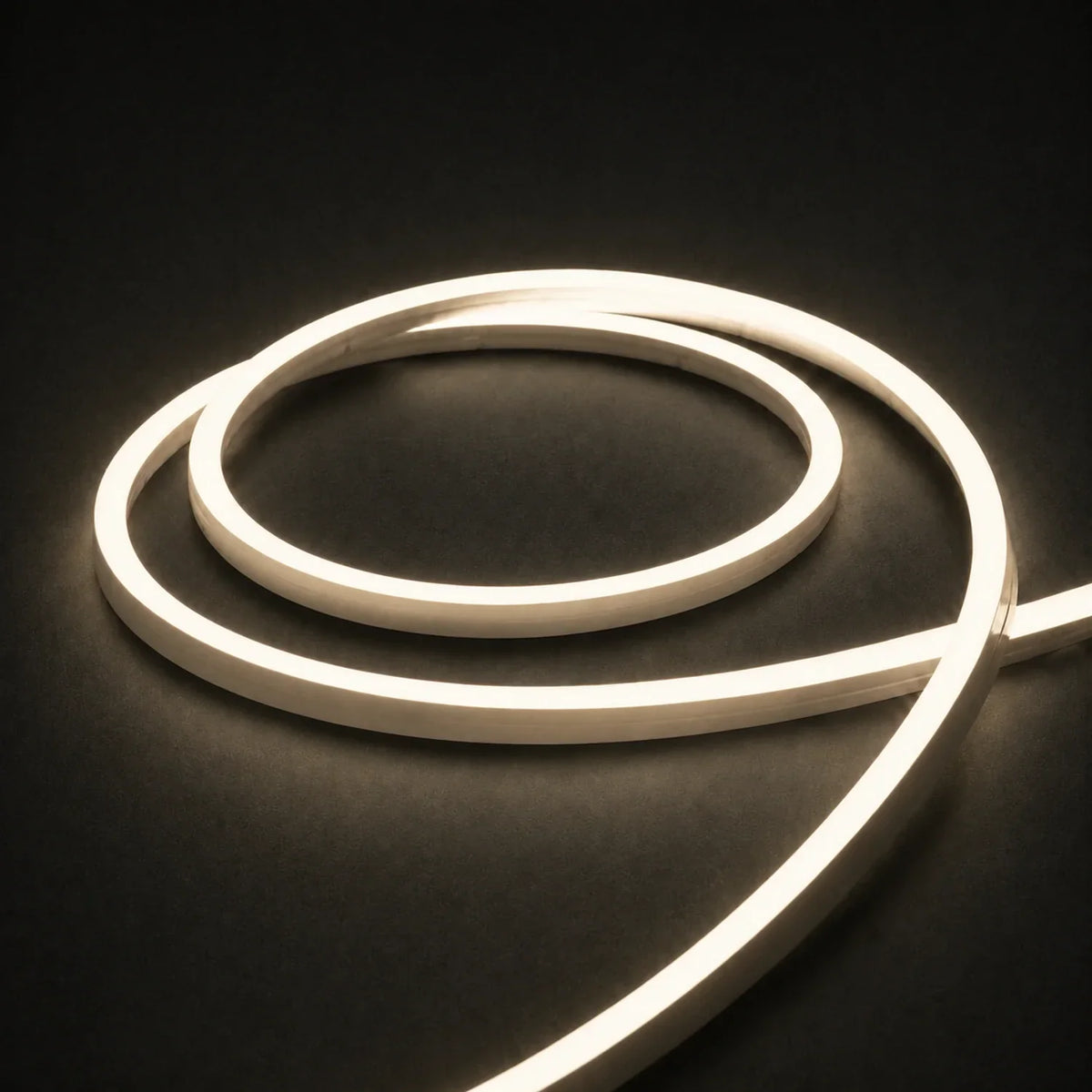 3000K side-bend Neon Flex coiled on a dark surface, colour-adjusted product photograph