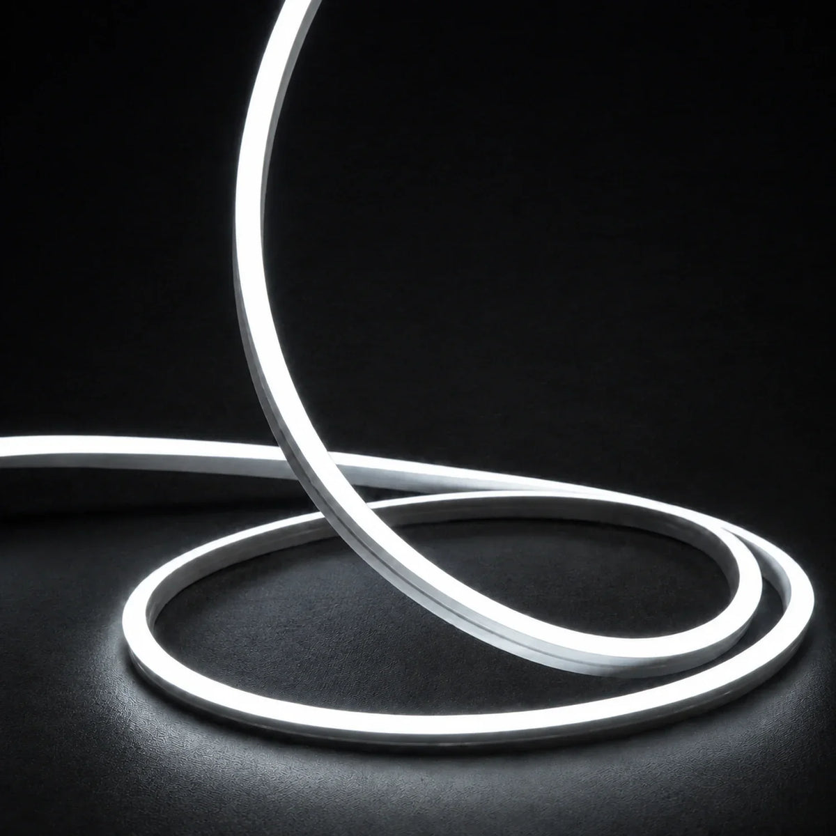 6000K side-bend Neon Flex raised in loops on a dark surface, colour-adjusted product photograph