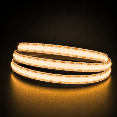 Warm White 2700K COB LED strip coil illuminated on a dark background, 24V DC and 10mm wide.