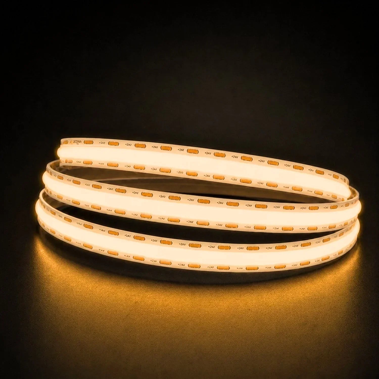 Warm White 2700K COB LED strip coil illuminated on a dark background, 24V DC and 10mm wide.
