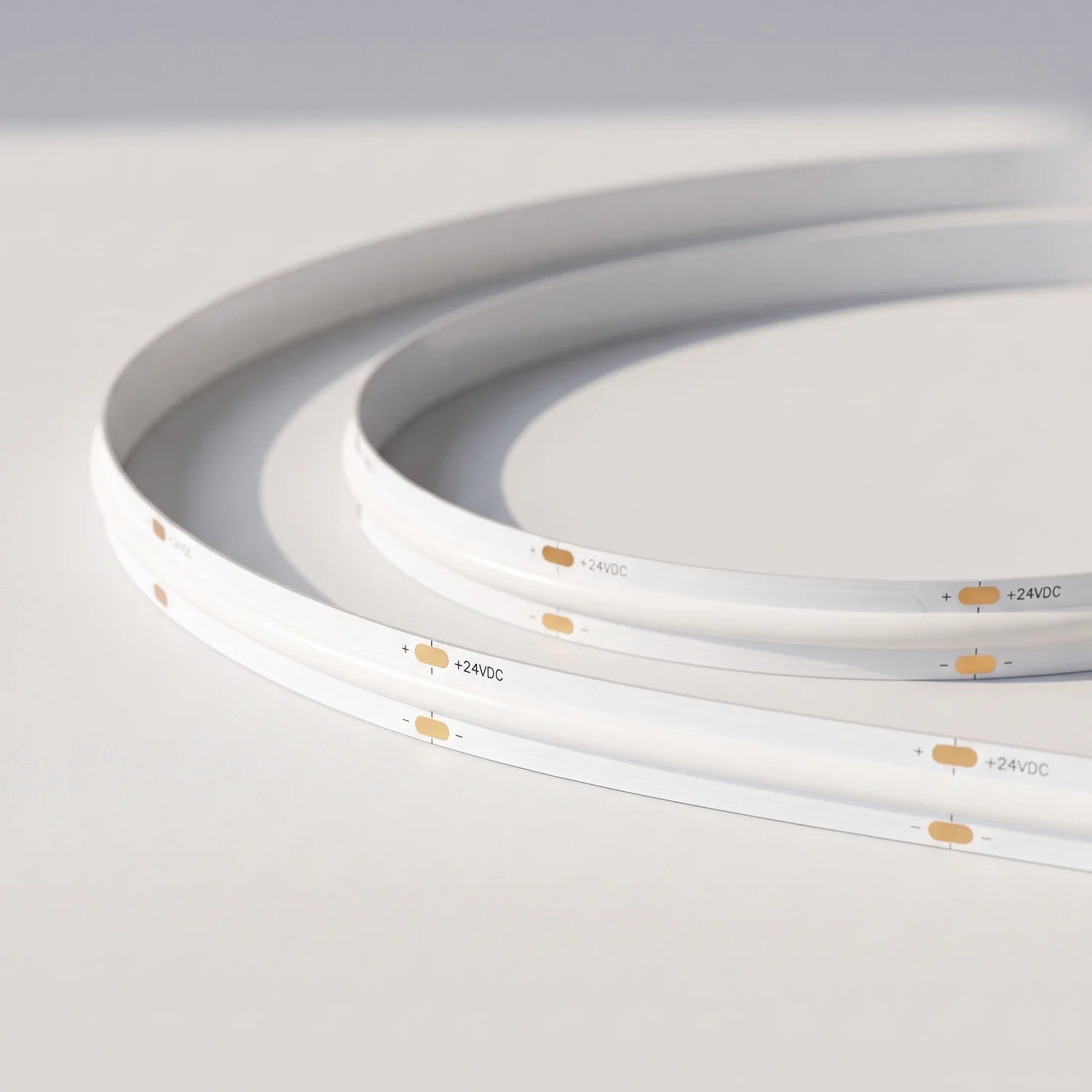 Unlit 10mm SCOB LED strip showing white board and 24V connection pads