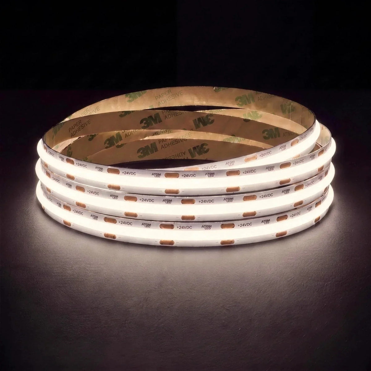 Natural White 4000K SCOB LED strip coil illuminated on a dark background, 24V DC and 10mm wide.