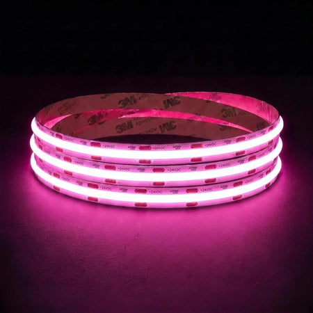 Pink SCOB LED strip coil illuminated on a dark background, 24V DC and 10mm wide.