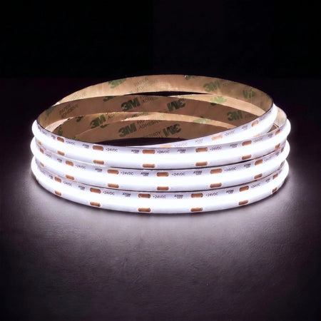 Daylight white 5000K SCOB LED strip coil illuminated on a dark background, 24V DC and 10mm wide, with copper connection pads