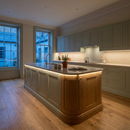 Warm White 3000K 24V 10mm COB LED strip installed beneath cabinets and around a British kitchen island; installation visual.
