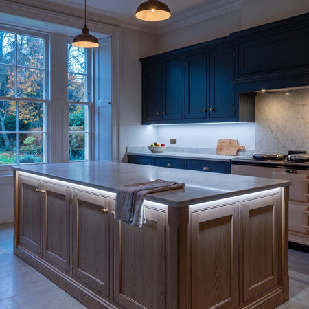 Cool White 6500K 24V 10mm COB LED strip installed beneath cabinets and around a British kitchen island; installation visual.